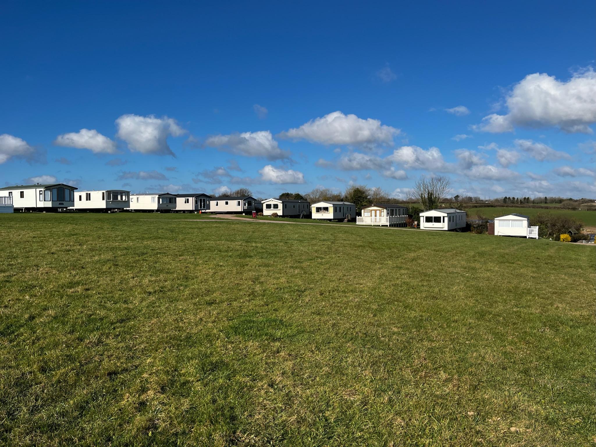 Wide shot of a caravans surrounding a large field